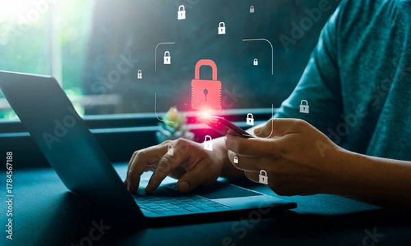 Fototapeta Cybersecurity and mobile data protection concept with person using smartphone, laptop with glowing digital padlock icon representing secure online access, privacy authentication, internet information