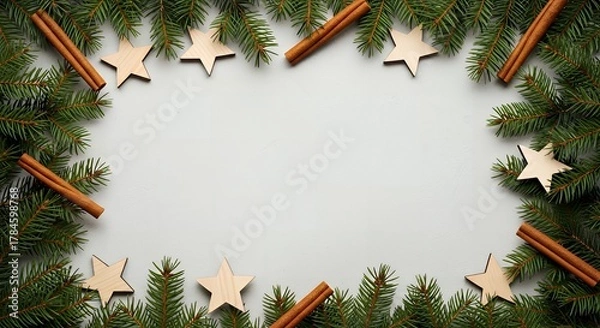 Fototapeta Festive Christmas border with evergreen branches, cinnamon sticks, and wooden stars