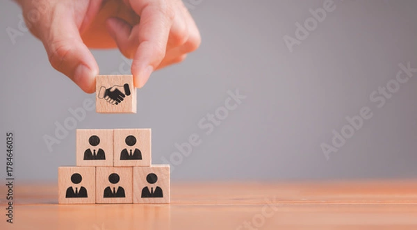 Fototapeta Empathy and teamwork in the workplace building trust and collaboration among employees with wooden blocks representing emotional intelligence and diversity