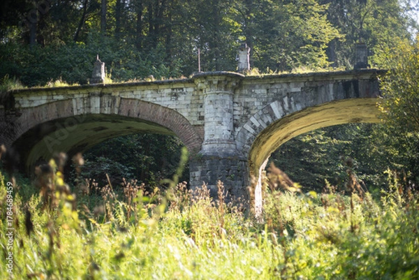 Fototapeta An ancient bridge. A ruined bridge of the 18th century. Architecture of the past.