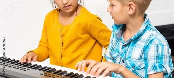 Fototapeta Brother And Sister Playing Piano