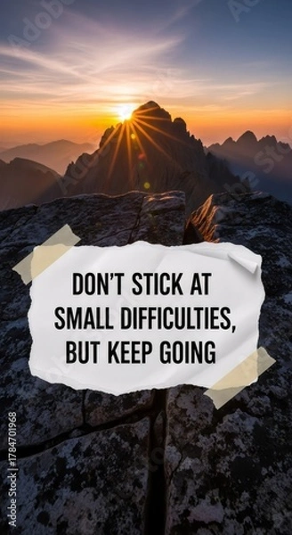 Fototapeta Inspirational quote on paper with mountain sunrise background. Motivational message for overcoming challenges. Business success and personal development.