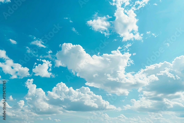 Fototapeta clear blue sky with soft white clouds, minimalistic background, high resolution, studio-grade lighting effect, perfect for text overlay