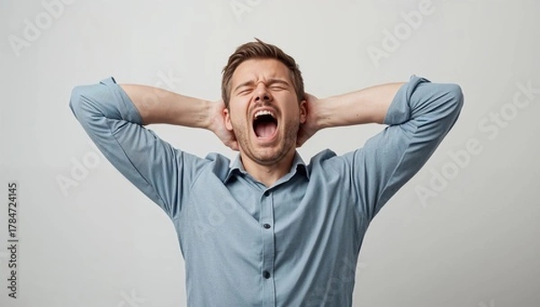 Obraz Frustrated man with hands on head screaming in exasperation, conveying stress and overwhelming pressure