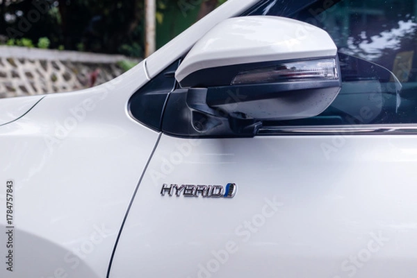 Fototapeta Hybrid emblem on the white car