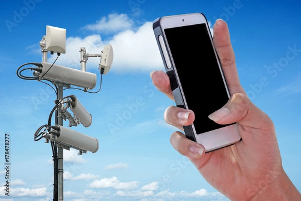 Fototapeta Cellular network antenna and handphone and blue sky.