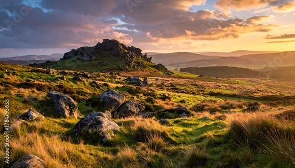 Obraz Dramatic sunset landscape with rocks, hills, and a cloudy sky view