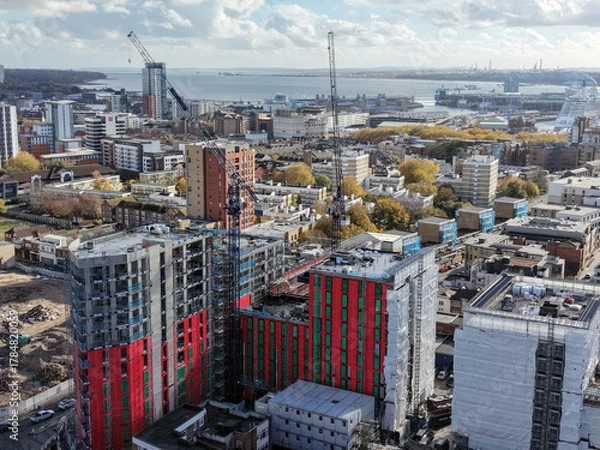 Fototapeta A construction site dominated by cranes , emphasizing growth and the evolution of the urban landscape in modern cities in London UK