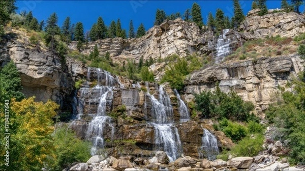 Fototapeta Majestic waterfalls cascading down rocky cliffs