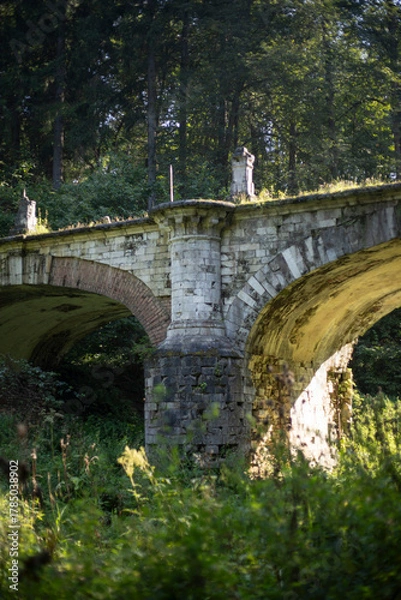 Fototapeta An old brick bridge. A vaulted bridge of the 18th century. A dried up river bed.