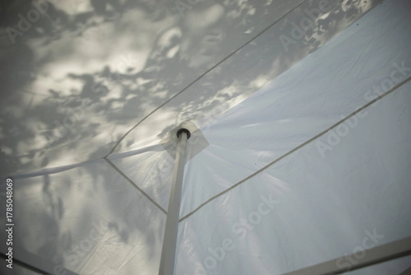 Obraz Tent construction. White tent. Tent roof. Mechanism for tensioning the fabric.