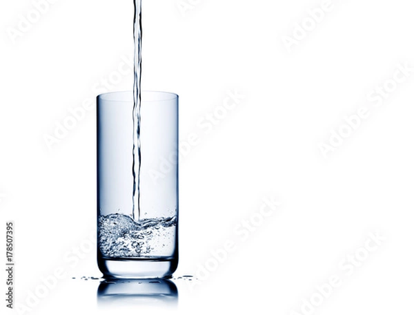 Obraz Water pouring and splashing into glass isolated on white with reflection