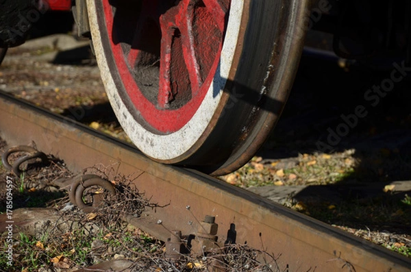 Fototapeta wheel of an old steam locomotive on railway rails close-up
