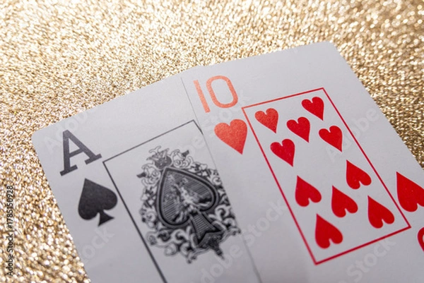 Obraz Photograph of a set of cards making a winning hand, Natural Blackjack, on a gold background