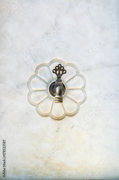 Obraz Vintage faucet protruding from marble wall