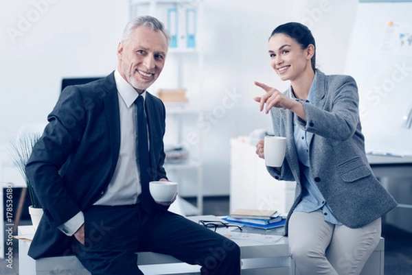 Fototapeta Smiling colleagues having lunch break and talking