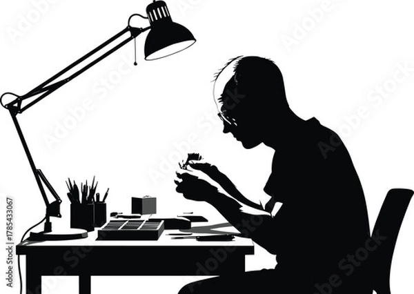 Obraz Focused desk work silhouette, black and white, hobbyist at table, model building, precision tools, lamp, workspace, concentration, creative activity