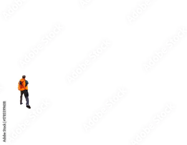 Fototapeta A person in a safety vest stands at the edge of a vast dark expanse, possibly a construction site