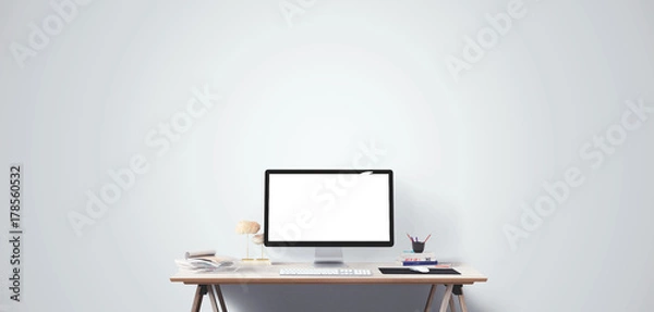 Fototapeta Computer display and office tools on desk. Desktop computer screen isolated. Modern creative workspace. Front view.