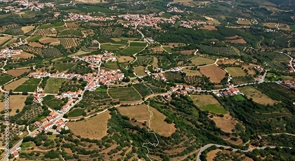 Fototapeta Aerial view showcases a charming European village nestled in a lush, rolling landscape
