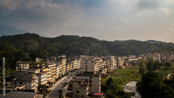 Obraz Riverside Town Surrounded by Forested Mountains