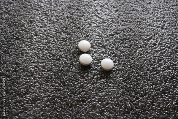 Fototapeta three pills on a gray background,