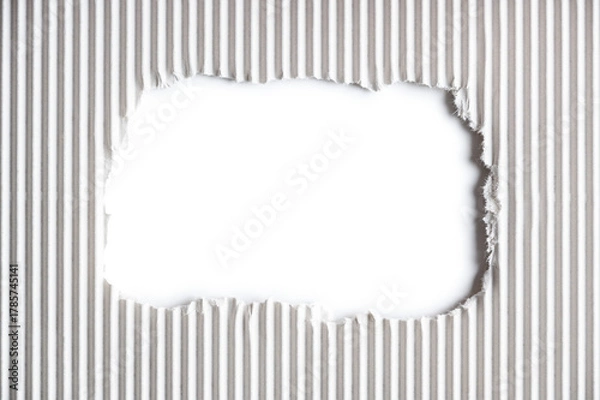 Fototapeta White corrugated paper with a hole with torn edges.