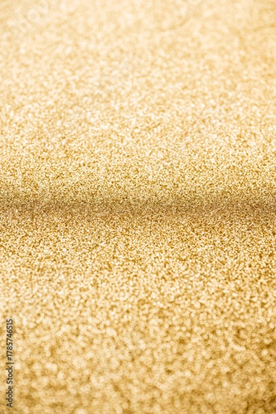 Fototapeta Abstract shiny gold glitter background with shallow depth of field.