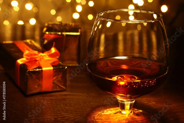 Obraz Whiskey, cognac, brandy and gift box on wooden table. Celebration composition on the light background.