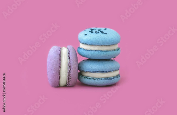 Obraz Three multicolored macarons on a pink background