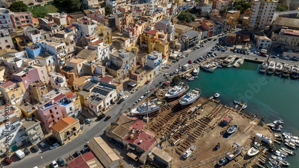 Fototapeta Aerial view of a small seaside village. The houses are located on the waterfront of Sciacca, in the province of Agrigento, Sicily, Italy. It overlooks Mediterranean Sea.