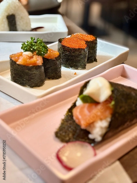 Fototapeta An incredibly delicious selection of sushi and rolls, a variety of fish, raw fish, avocado, wasabi, soy sauce, sesame seeds, chopsticks, Japanese food.