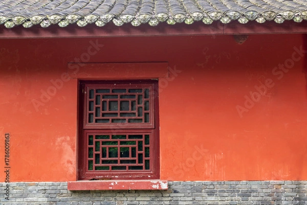 Fototapeta The traditional Chinese ancient-style building features red tiled houses