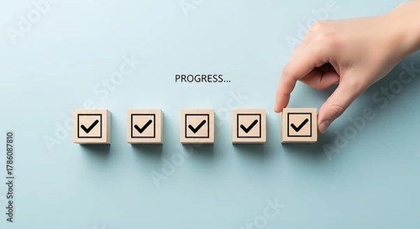 Obraz Hand Placing Last Checkmark Block Completing a Row of Five Progress Blocks checklist