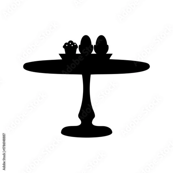 Fototapeta Silhouette image of eggs and a cupcake on a cake stand or table