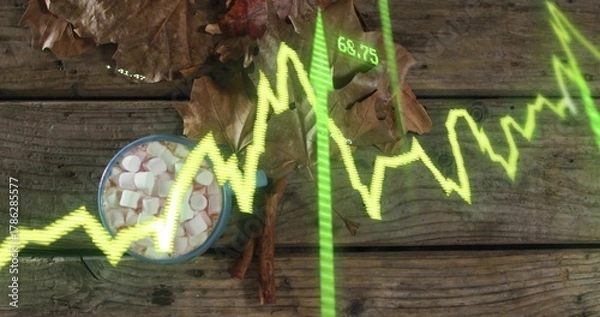 Obraz Displaying mug with marshmallows on wood table at park, showing leaves, cinnamon, neon graph 68