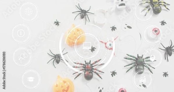 Obraz Showing red-accented black toy spider sitting centered on pale table, with Halloween props and HUD
