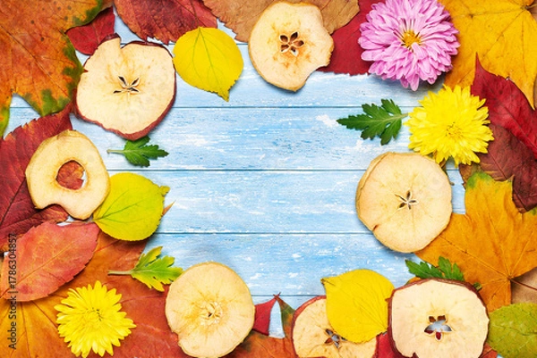 Fototapeta background of autumn leaves and flowers yellow, red on a wooden background and a place for writing