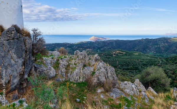 Fototapeta Panoramic landscape view of Crete coast with rocky foreground and distant island