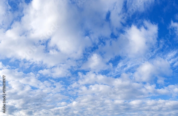 Obraz Blue sky with scattered white clouds on a sunny day