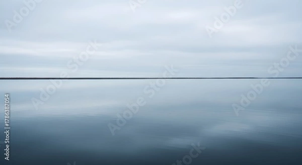 Obraz Tranquil water surface reflecting overcast sky minimalist abstract