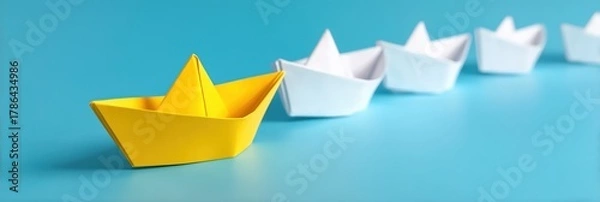 Fototapeta Boat paper concept yellow ship business leadership leader lead origami partnership. Background boat paper concept change journey success crew blue compass unique different fleet join team challenge