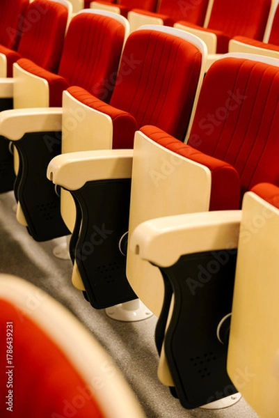 Fototapeta Empty red cinema seats in an auditorium