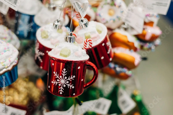 Fototapeta Colorful holiday decorations featuring red mugs with snowflakes and festive toppings on display