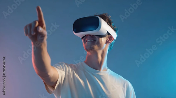 Fototapeta Young man using virtual reality headset in modern studio environment