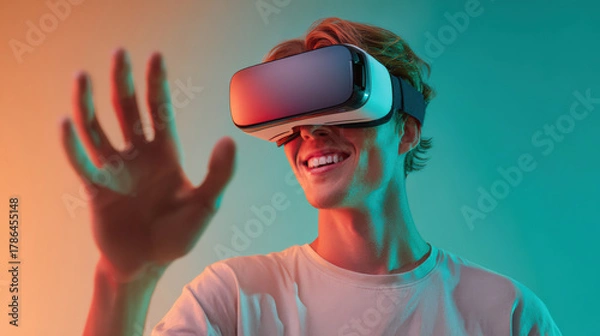 Fototapeta Smiling man exploring augmented virtual world through VR headset