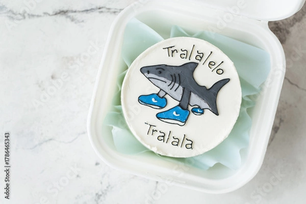 Fototapeta Bento cake with shark in a boots drawing on top. Tralalelo Tralala trendy viral expression