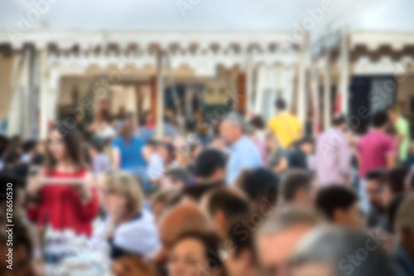 Fototapeta blurred crowd in a food festival, image of people not on focus (the picture is voluntarily defocused for background usage)