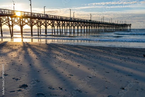Obraz Sunrise Casting Pier Shadows on Beach
