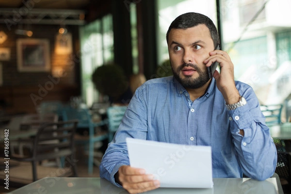 Obraz Young man using phone